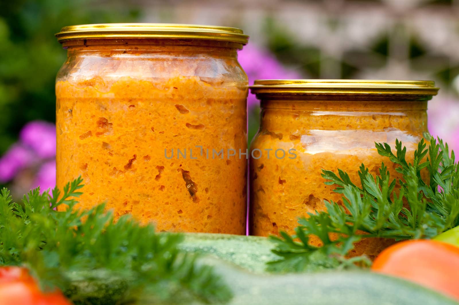 canned vegetables zucchini in a glass jar by olgavolodina