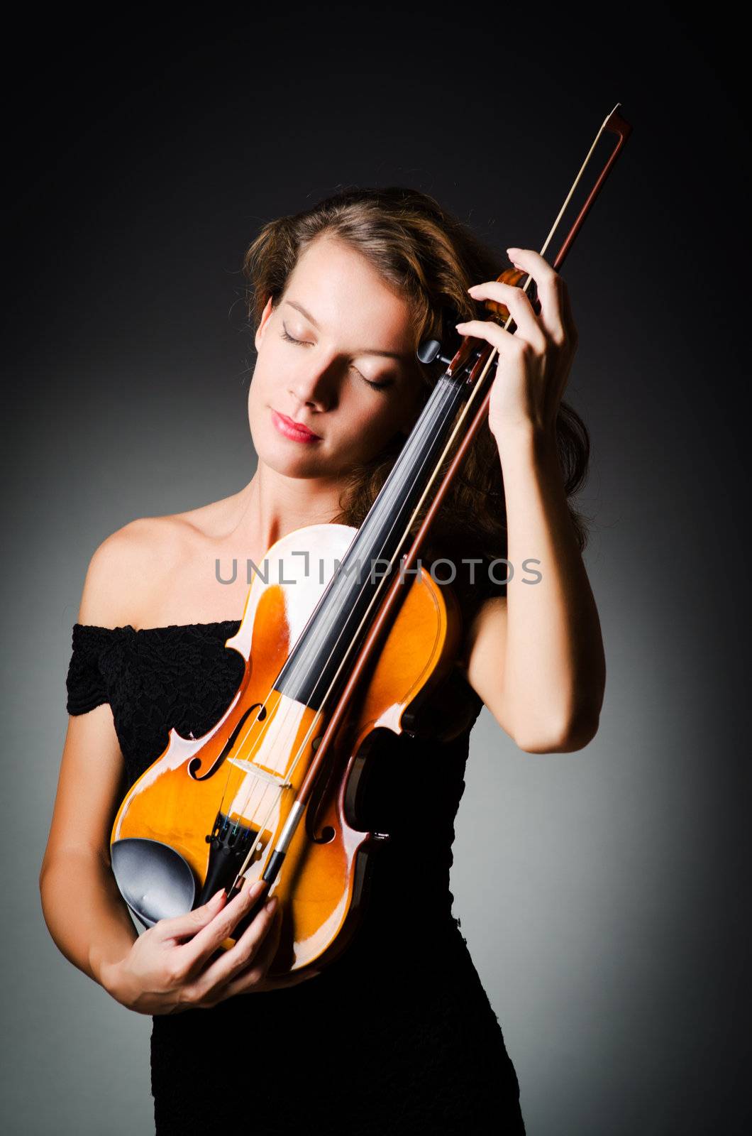 Woman with violin in dark room by Elnur