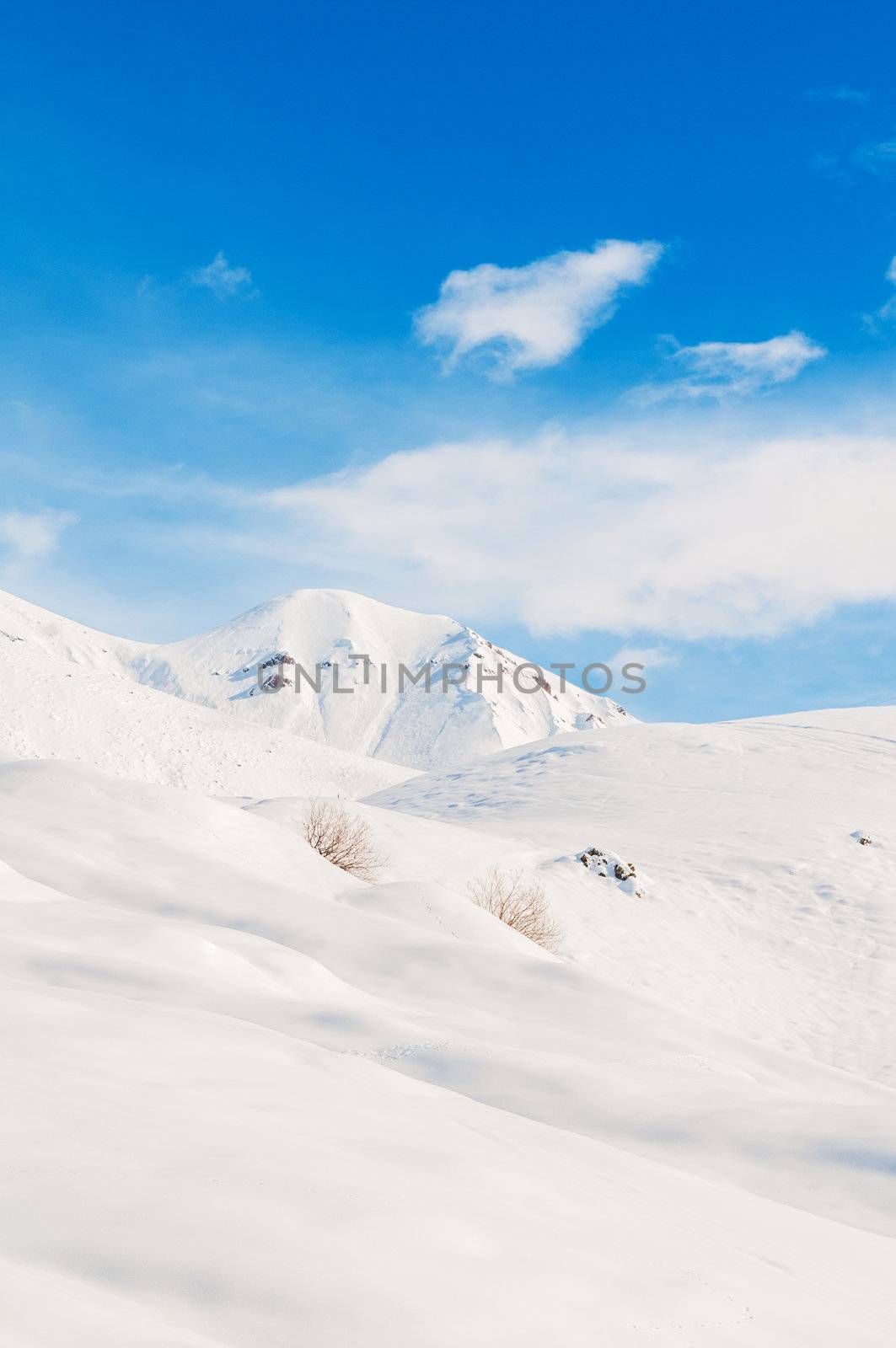 Snow mountains on bright winter day by Elnur