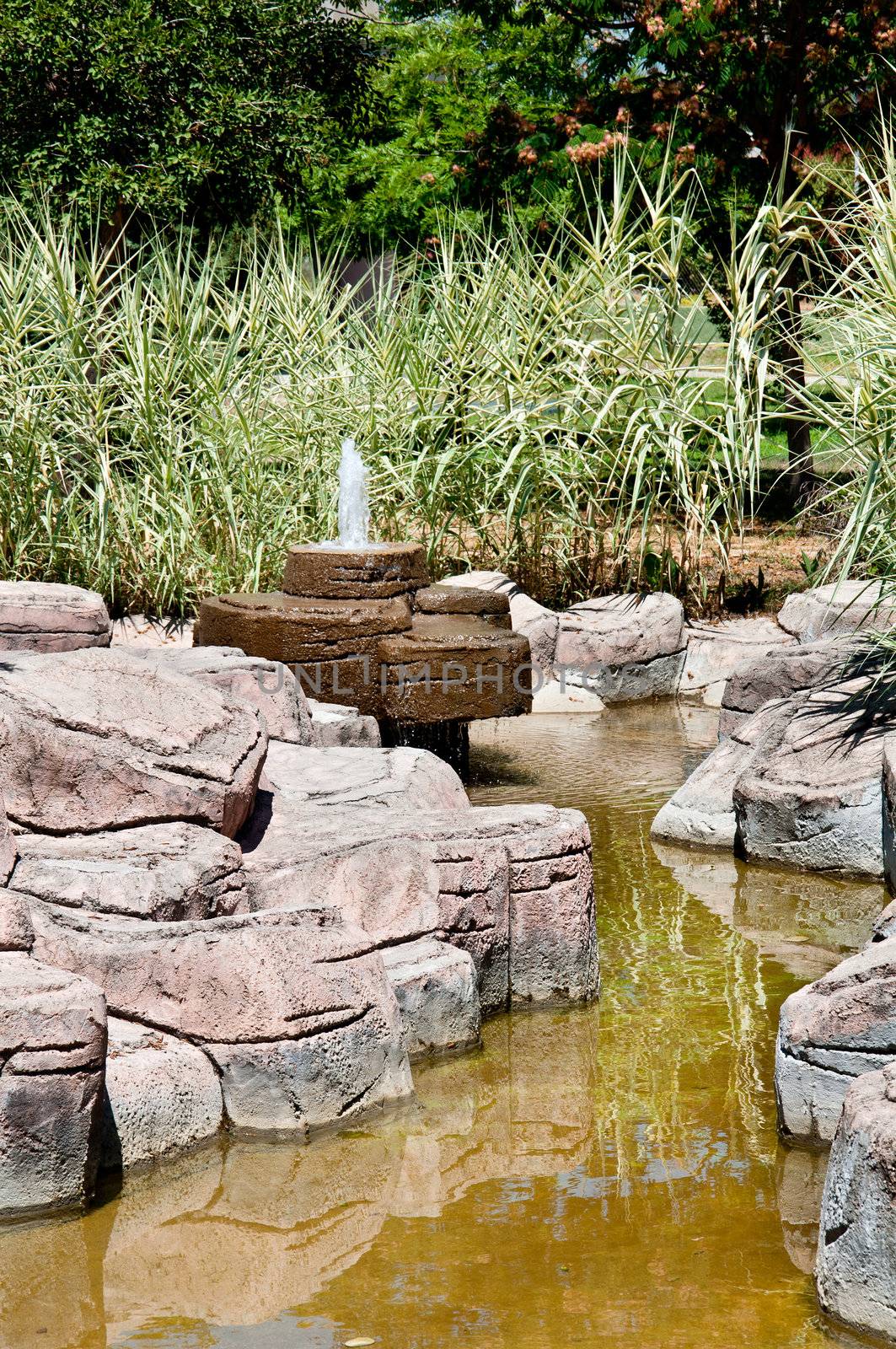 Landscaping - a stone fountain and pond