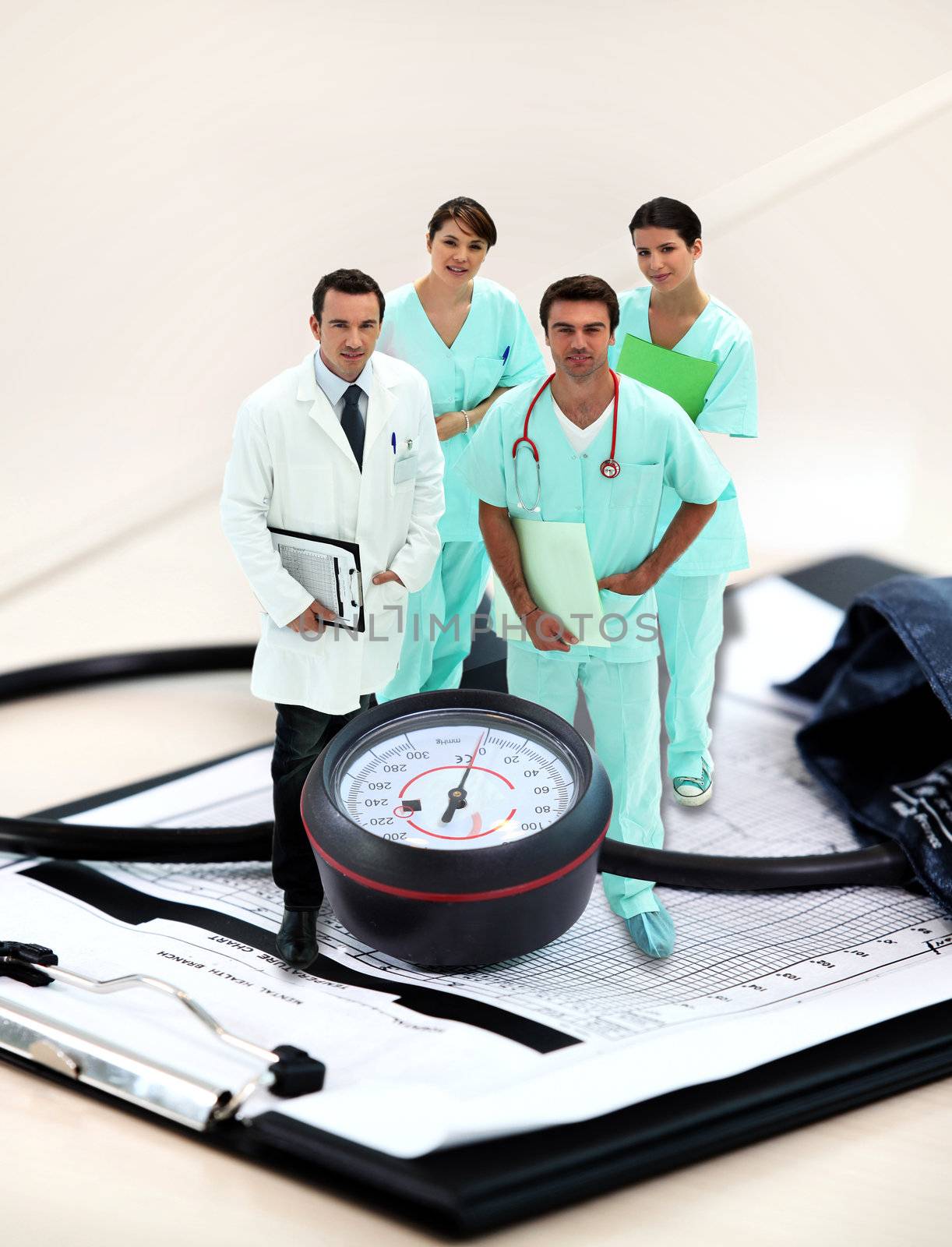 portrait of medical staff amid giant clipboard and sphygmomanometer by phovoir