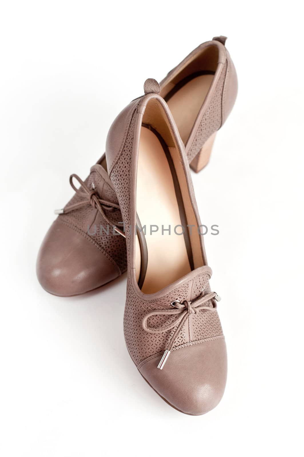 Beige female shoes on a light background