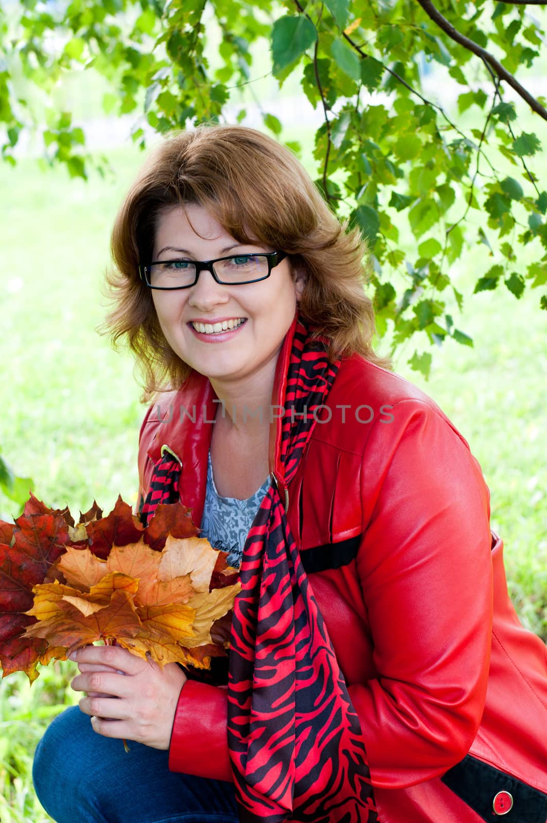 Woman with glasses in the park by olgavolodina