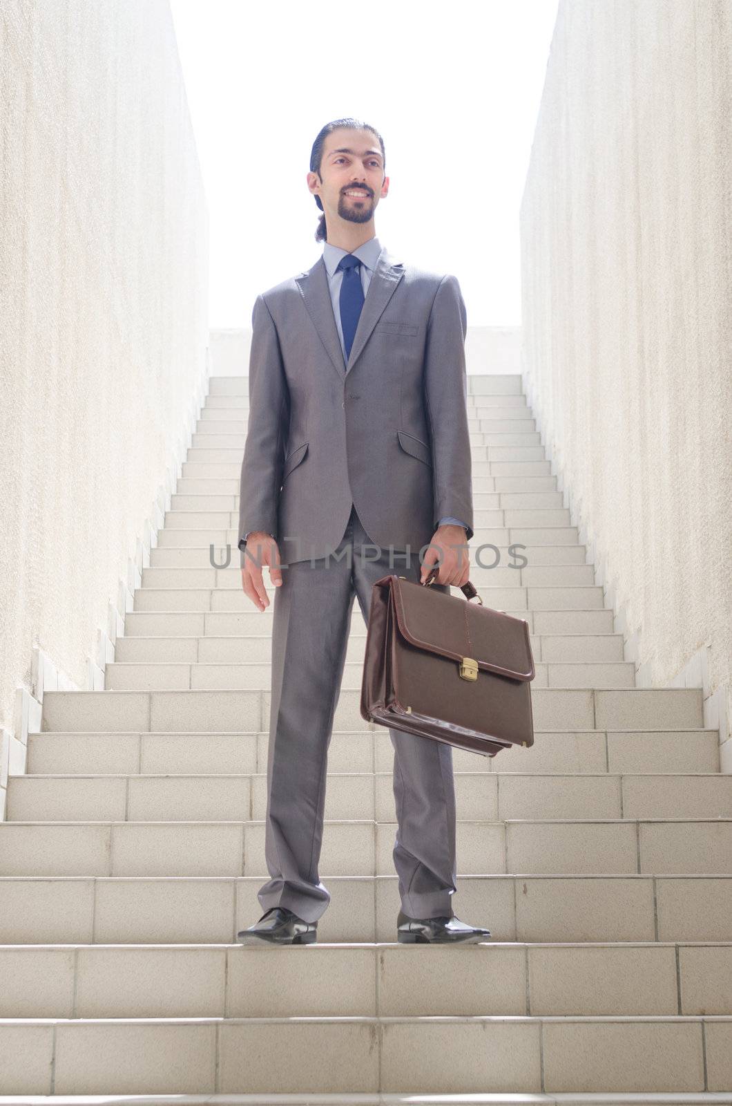 Businessman with stair in business concept by Elnur