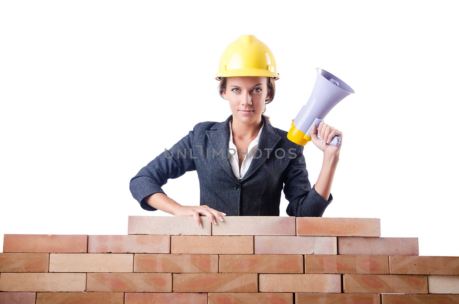Woman builder with loudspeaker on white by Elnur
