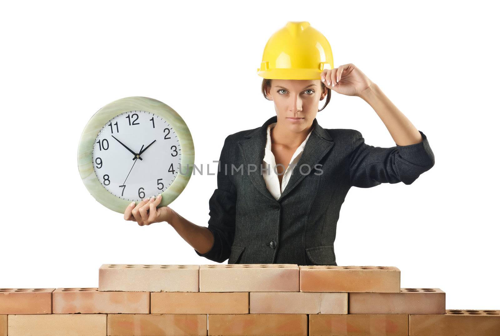 Female builder and clock on white by Elnur