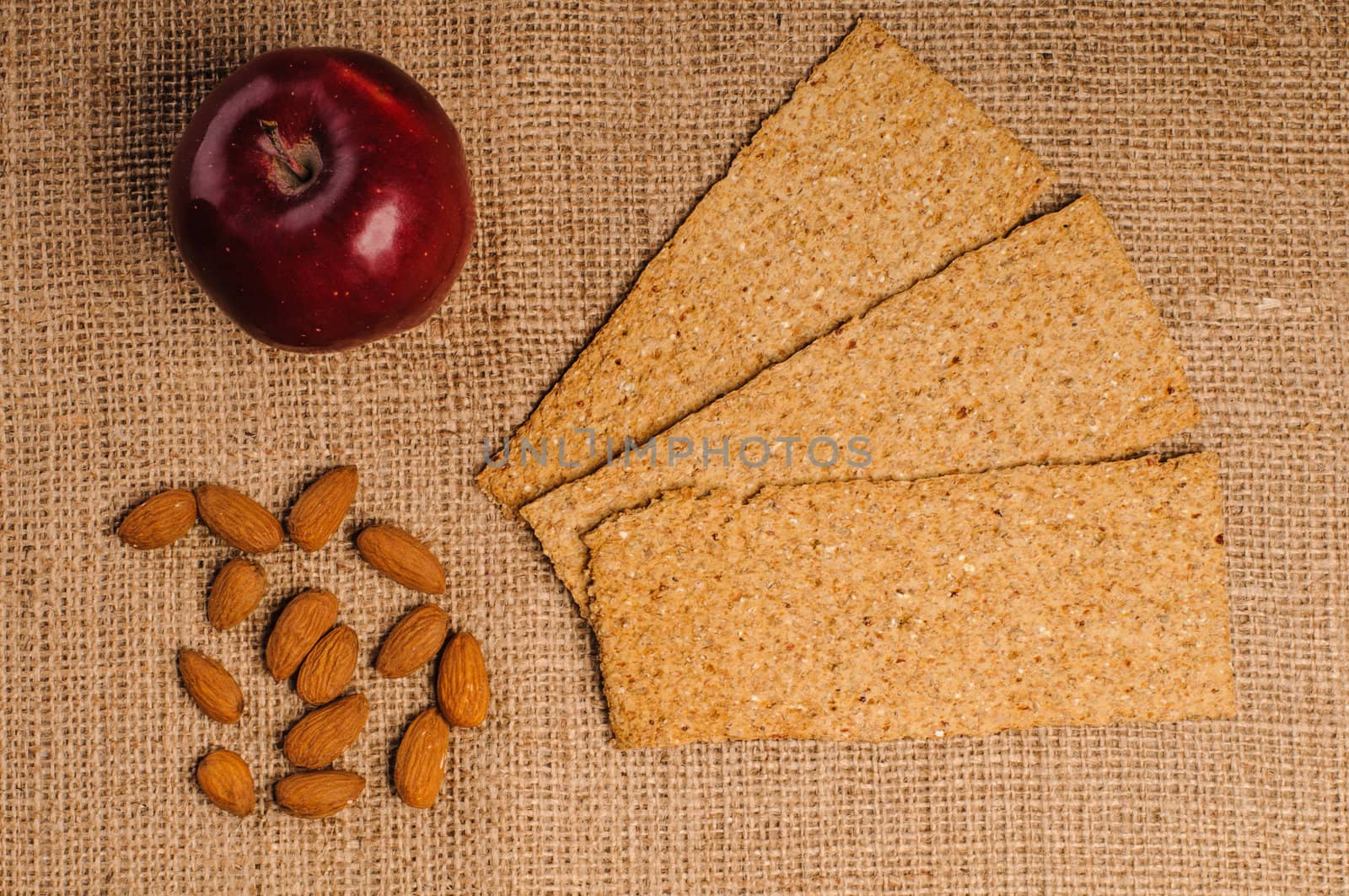 Red apple with crispbread and almonds by nvelichko