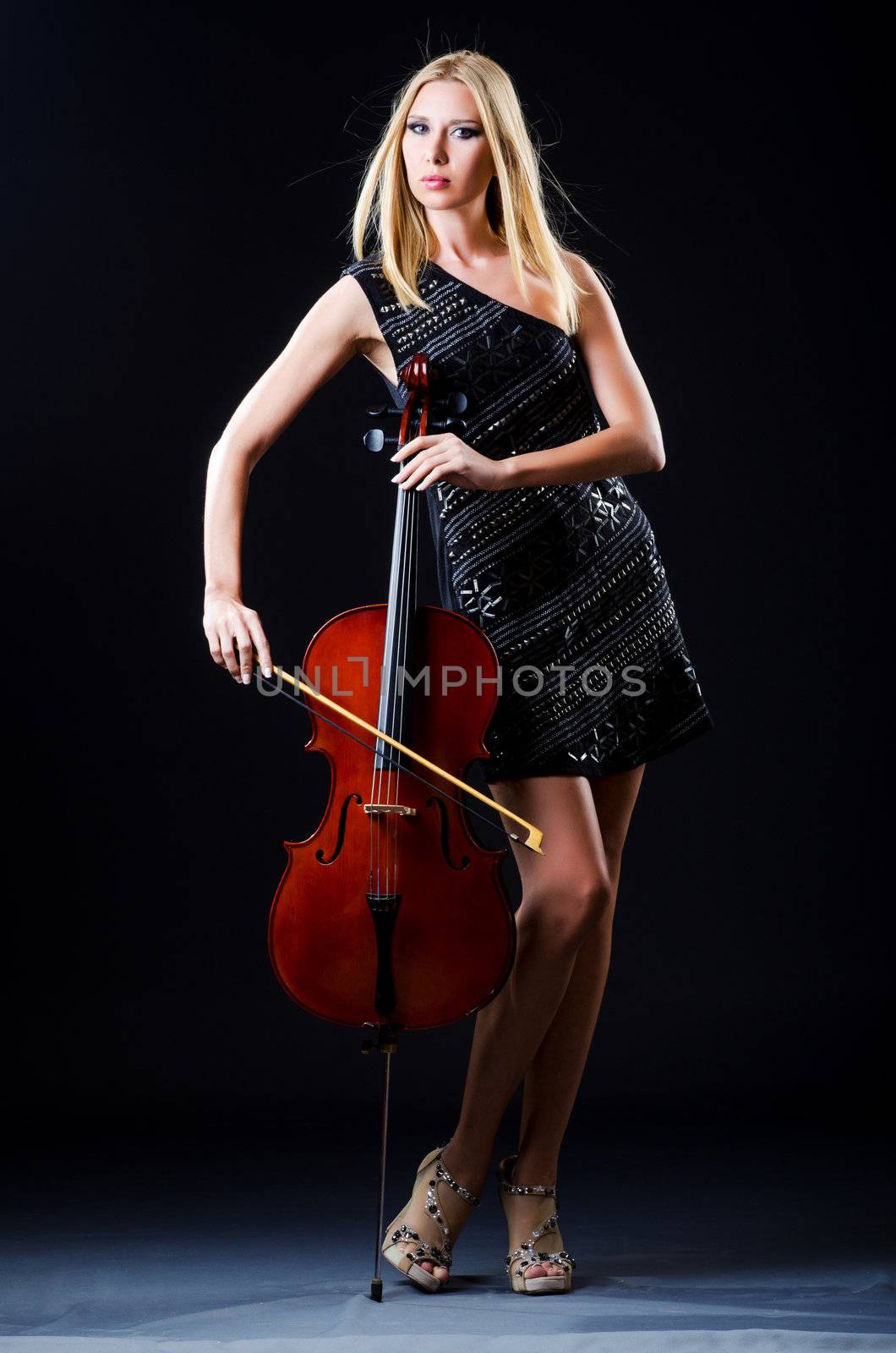 Woman playing cello on white by Elnur
