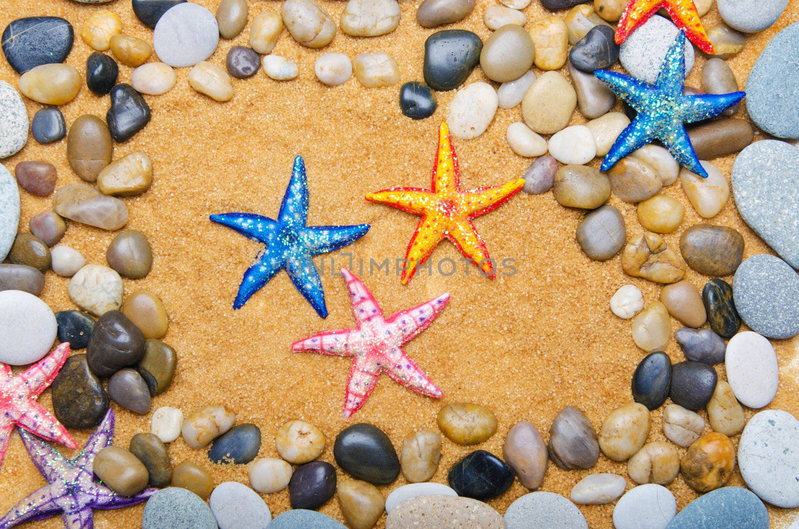 Sea stars and pebbles on sand