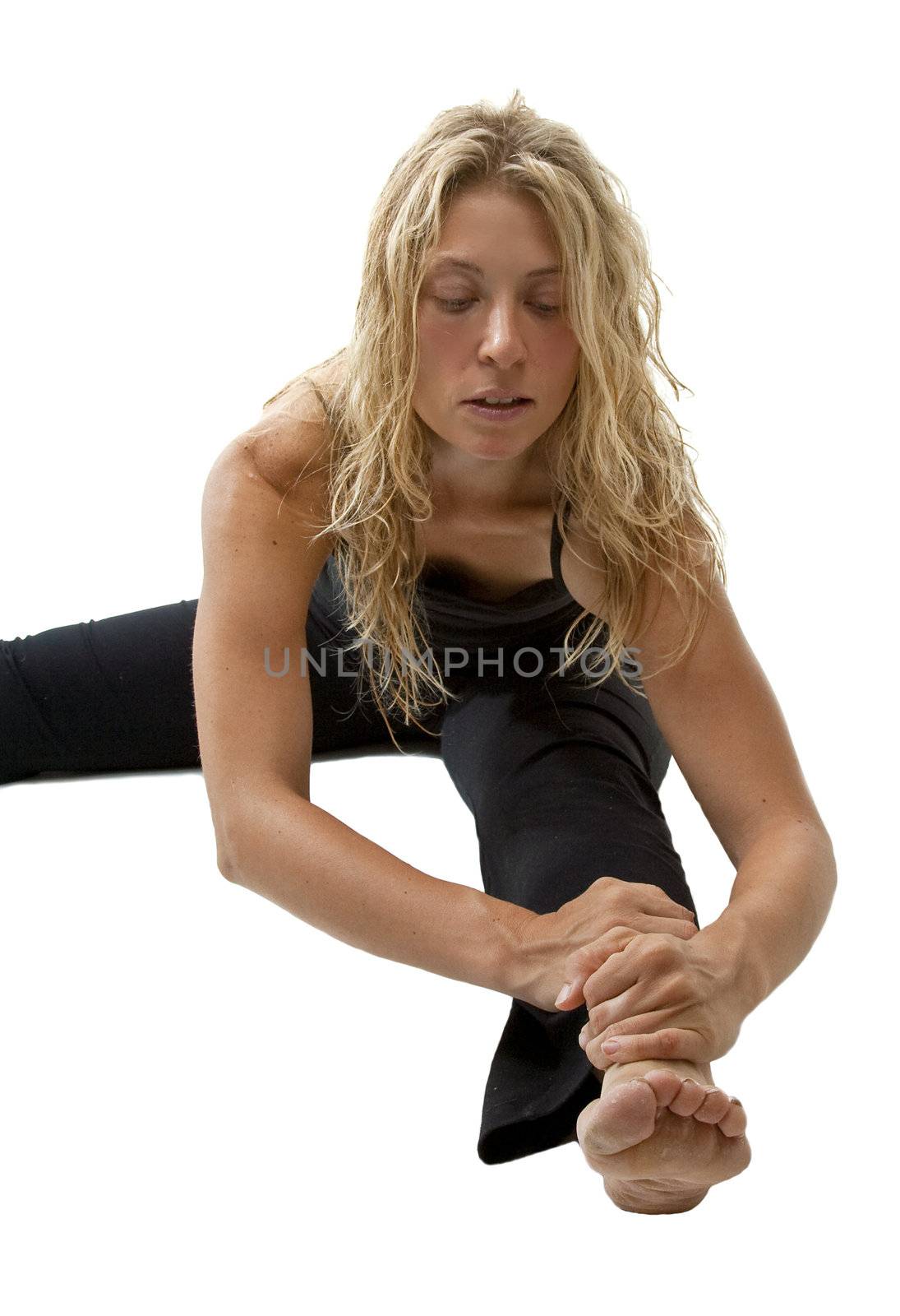 Blond woman bends, preparing for Yoga exercise