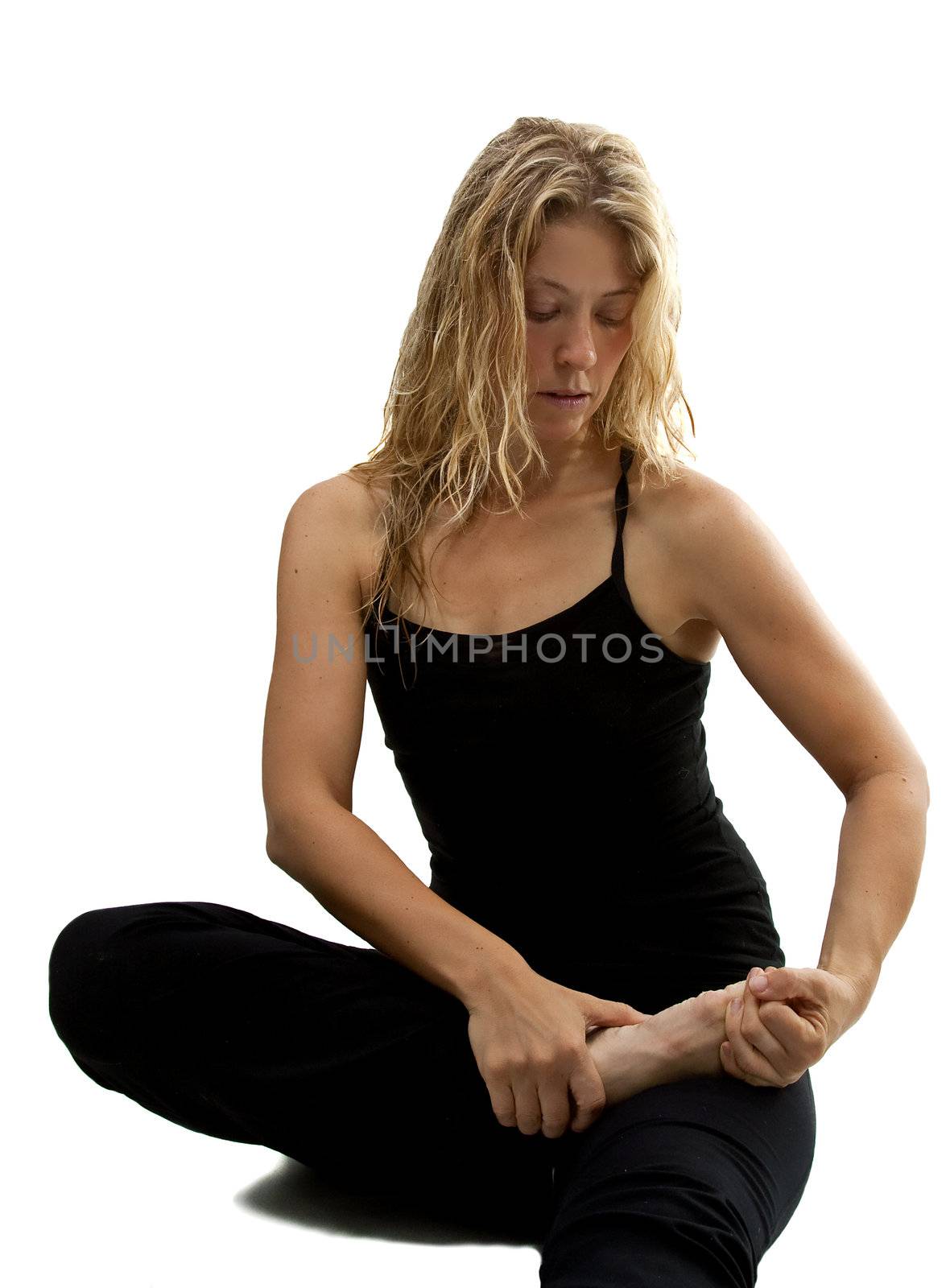 Blond woman streches, preparing for Yoga exercise, isolated over white
