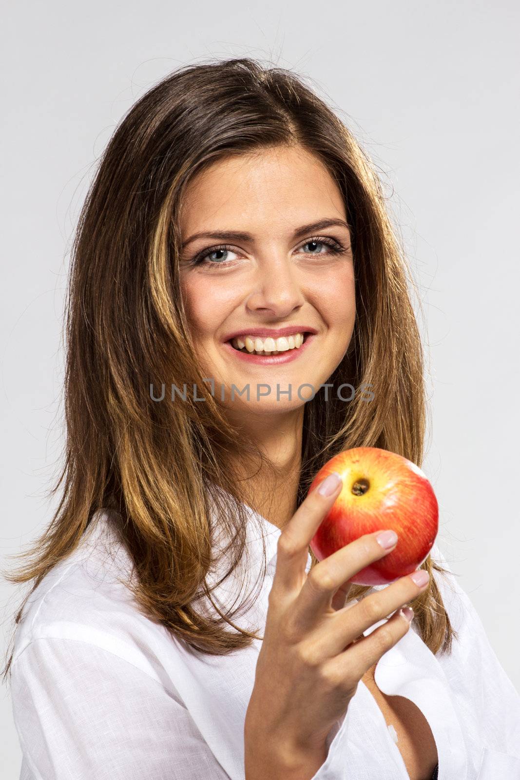 Woman with apple in man`s shirt