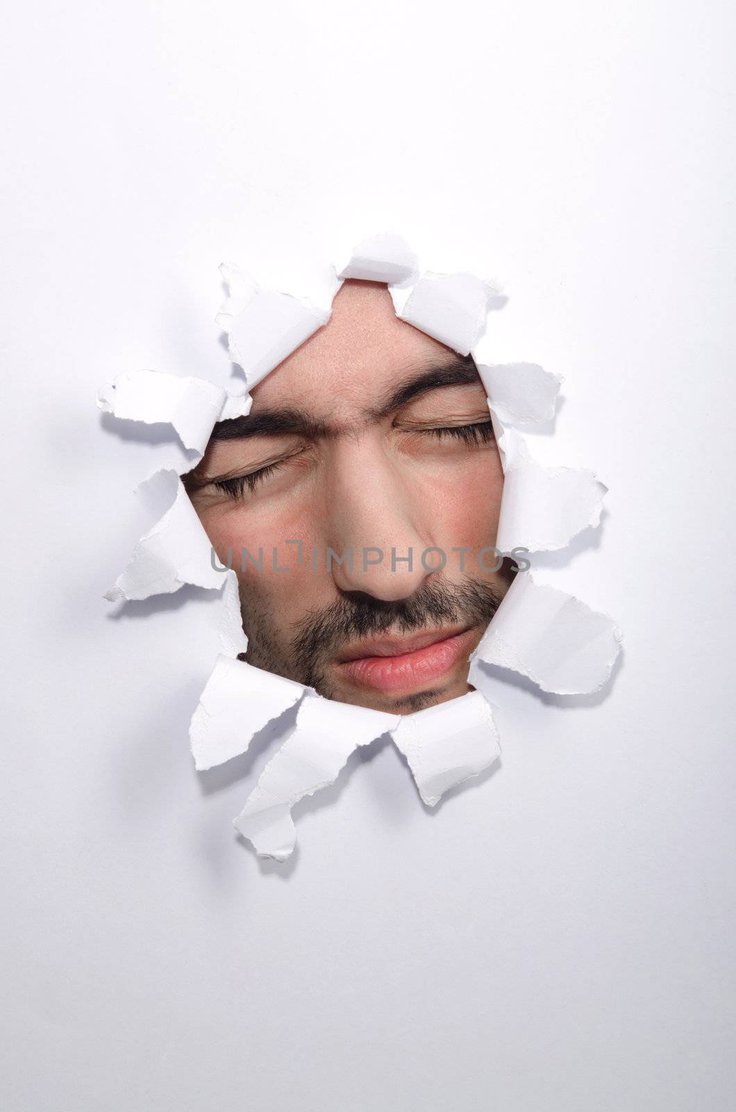 Male face through the hole in paper by Elnur