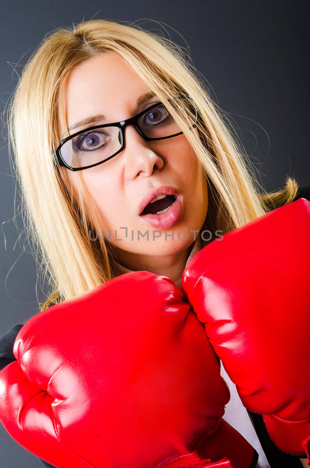 Woman boxer in dark room