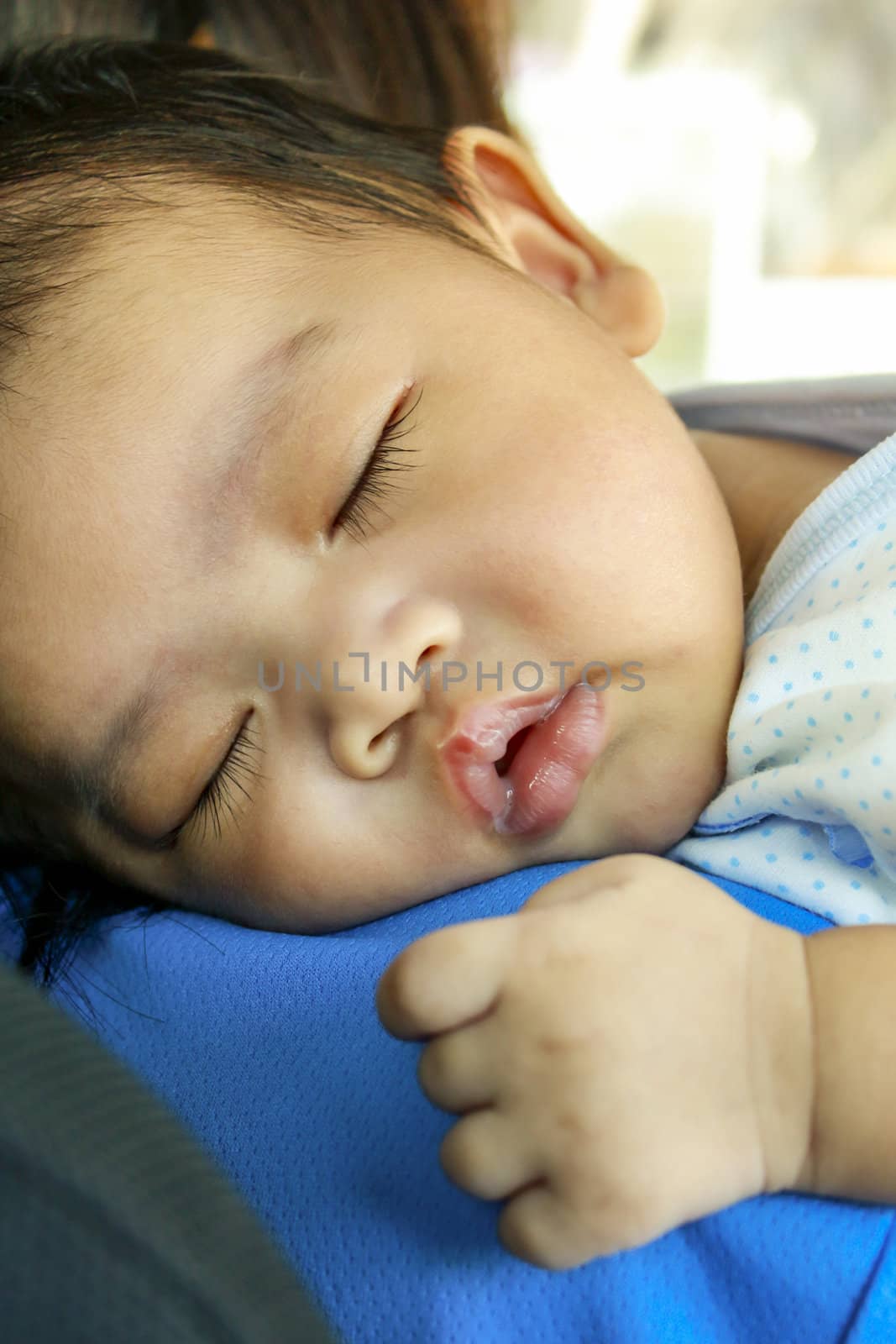 Closeup of Asian baby sleep with her mum