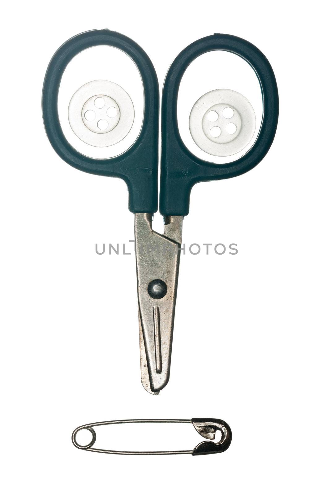 Scissors buttons and safety pin in shape of face isolated against white