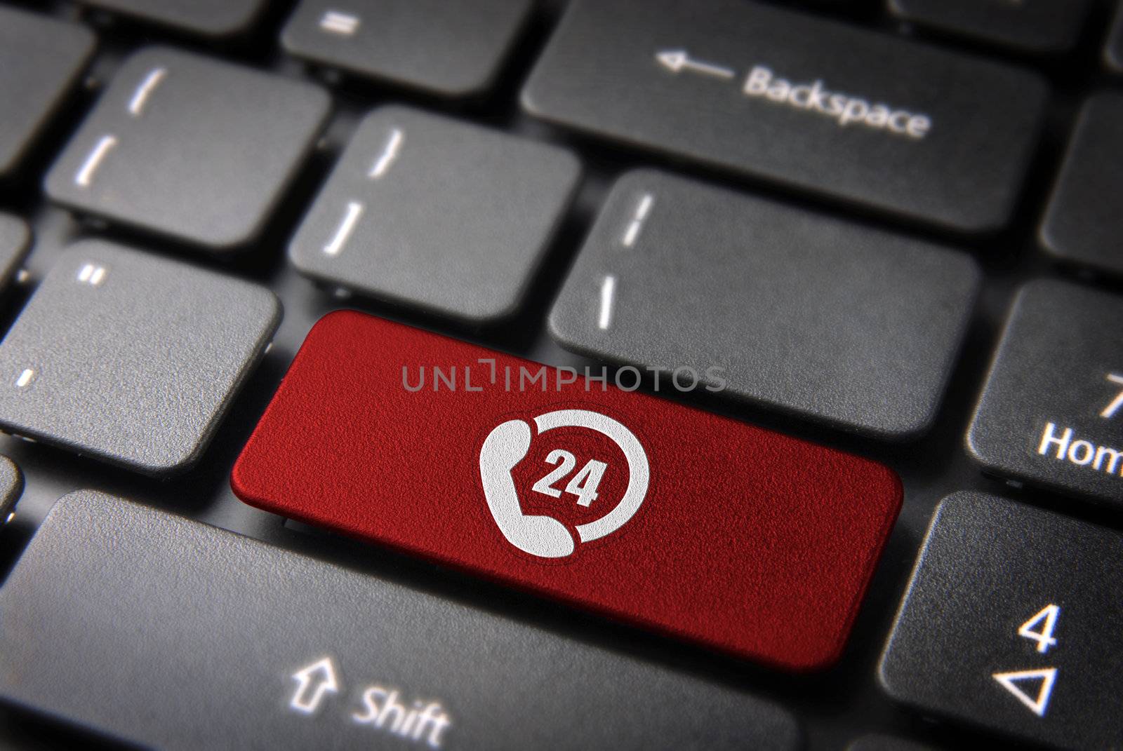 Online business always open concept: red key with 24 hours phone support symbol on laptop keyboard. Included clipping path, so you can easily edit it.