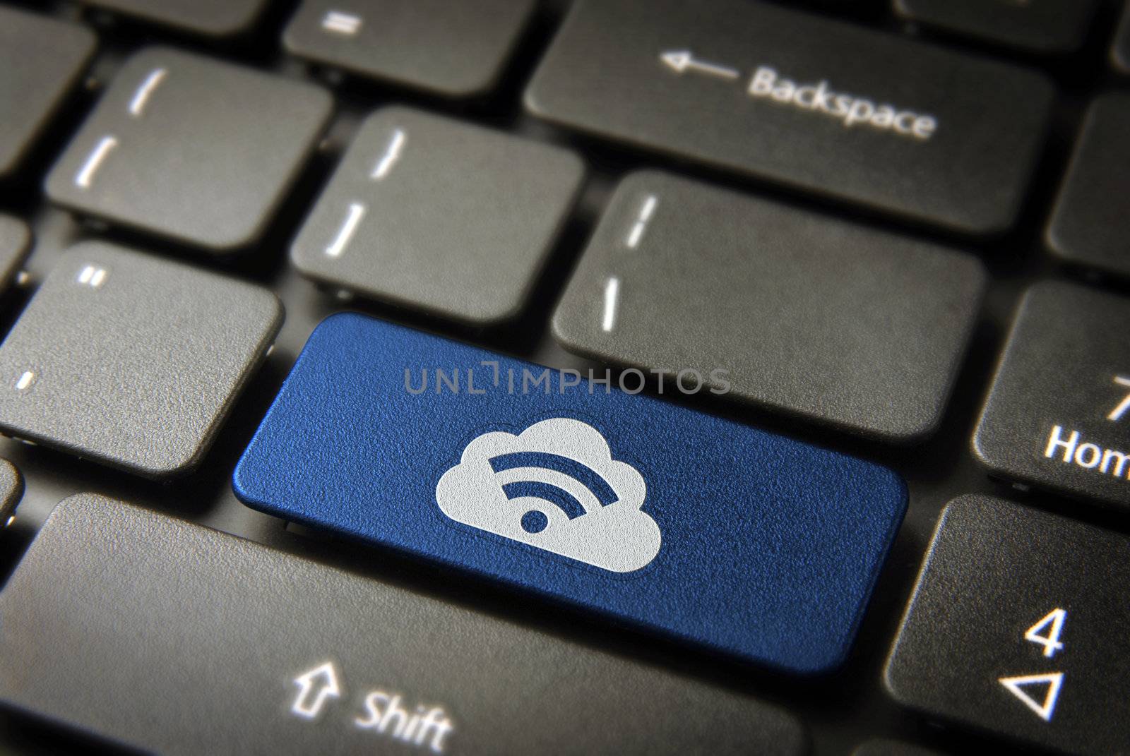 Blue technology key with RSS symbol and cloud computing icon on laptop keyboard. Included clipping path, so you can easily edit it.