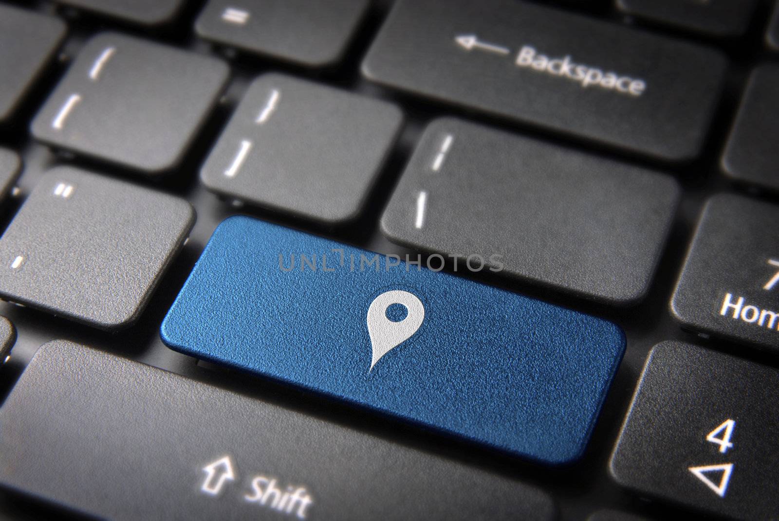 Blue key with geo location icon on laptop keyboard. Included clipping path, so you can easily edit it.