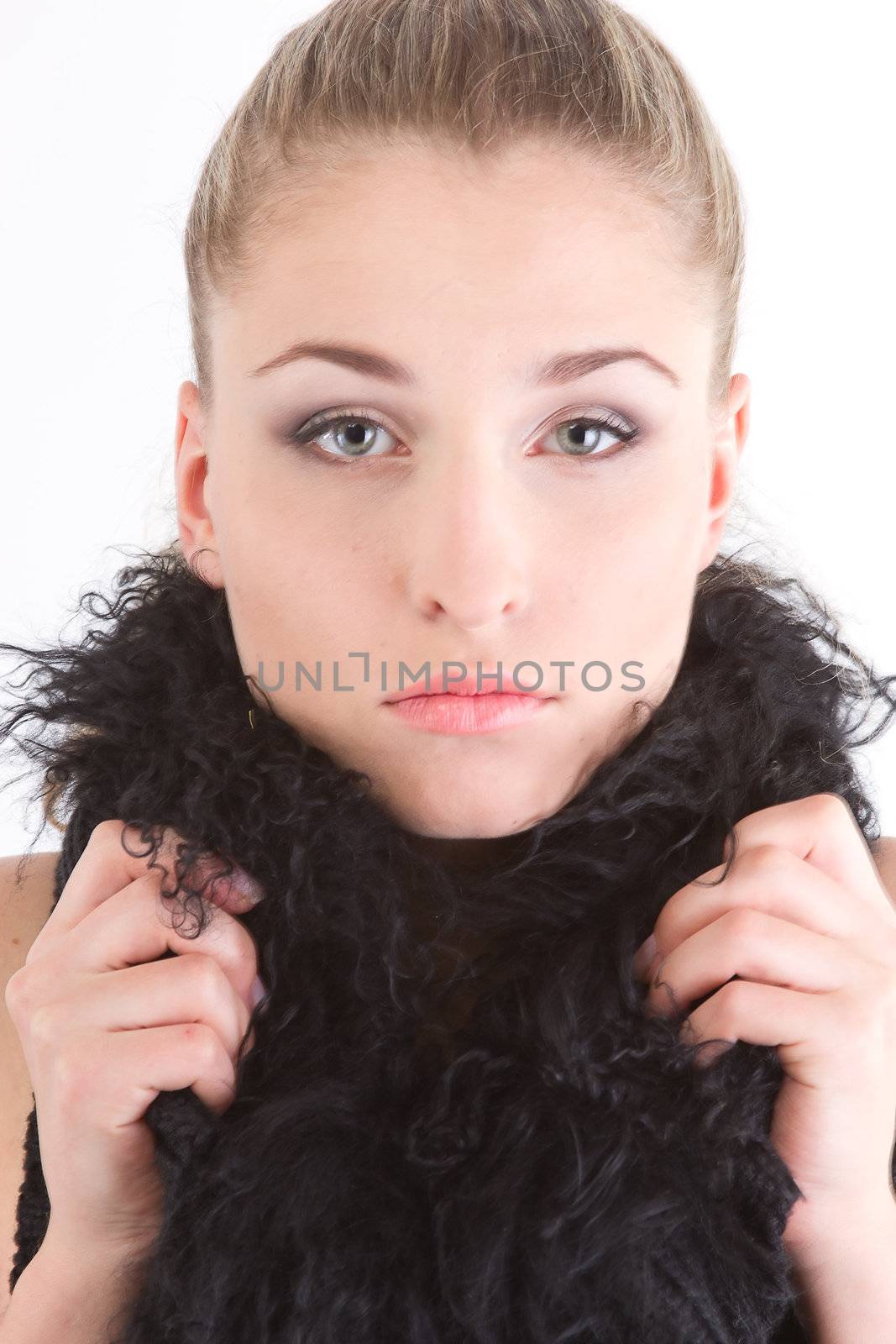 young beautiful girl in a black fur coat
