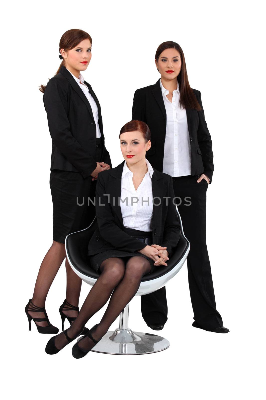 three elegant women in suits