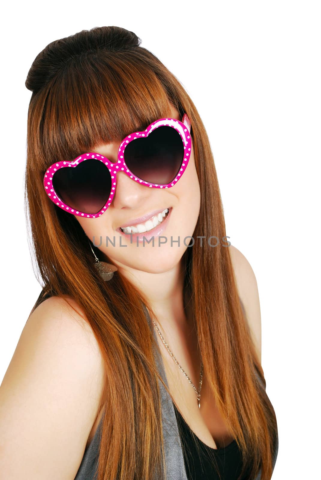 Happy teenage girl with heart sunglasses studio shot