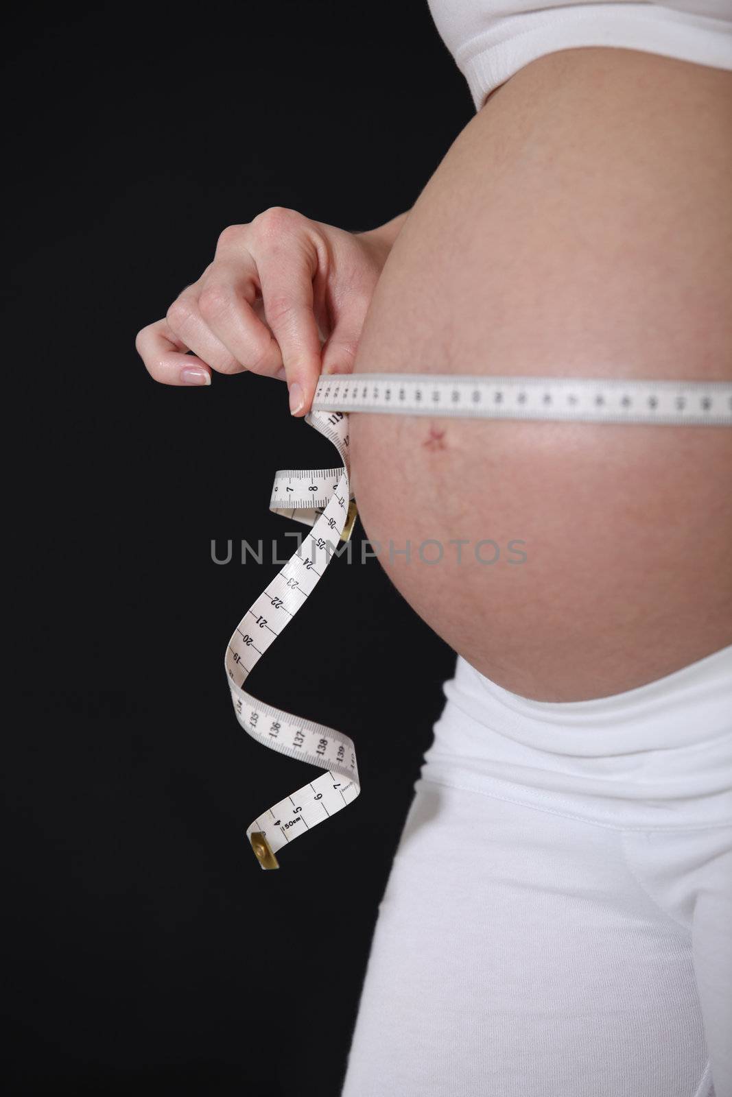 Pregnant lady measuring belly by phovoir