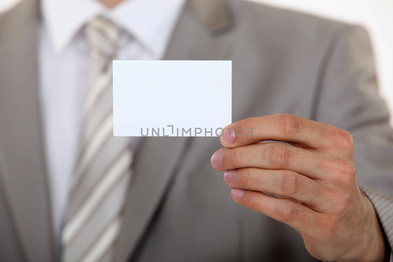 Man holding up a blank business card