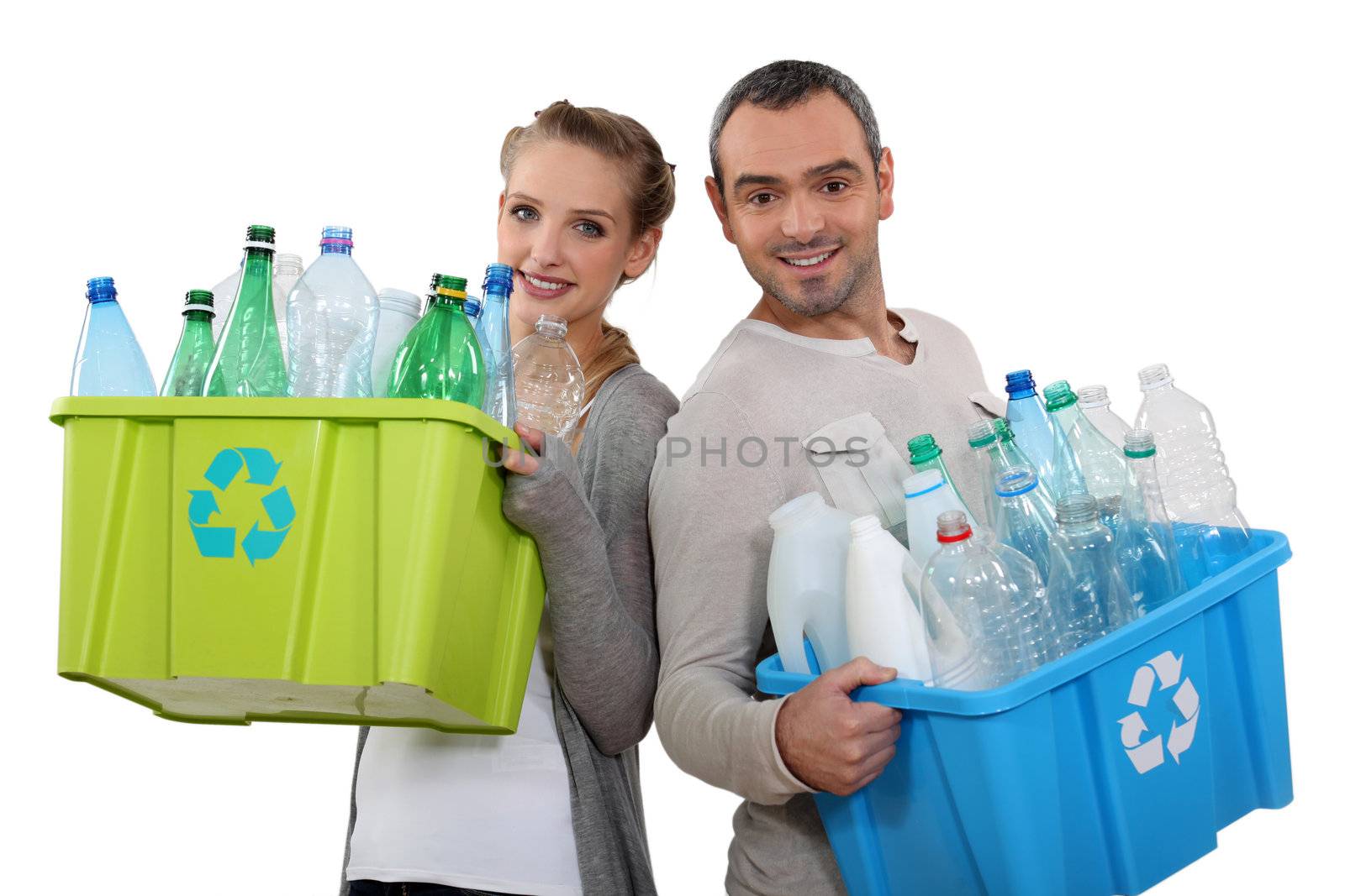 Couple recycling empty plastic bottles