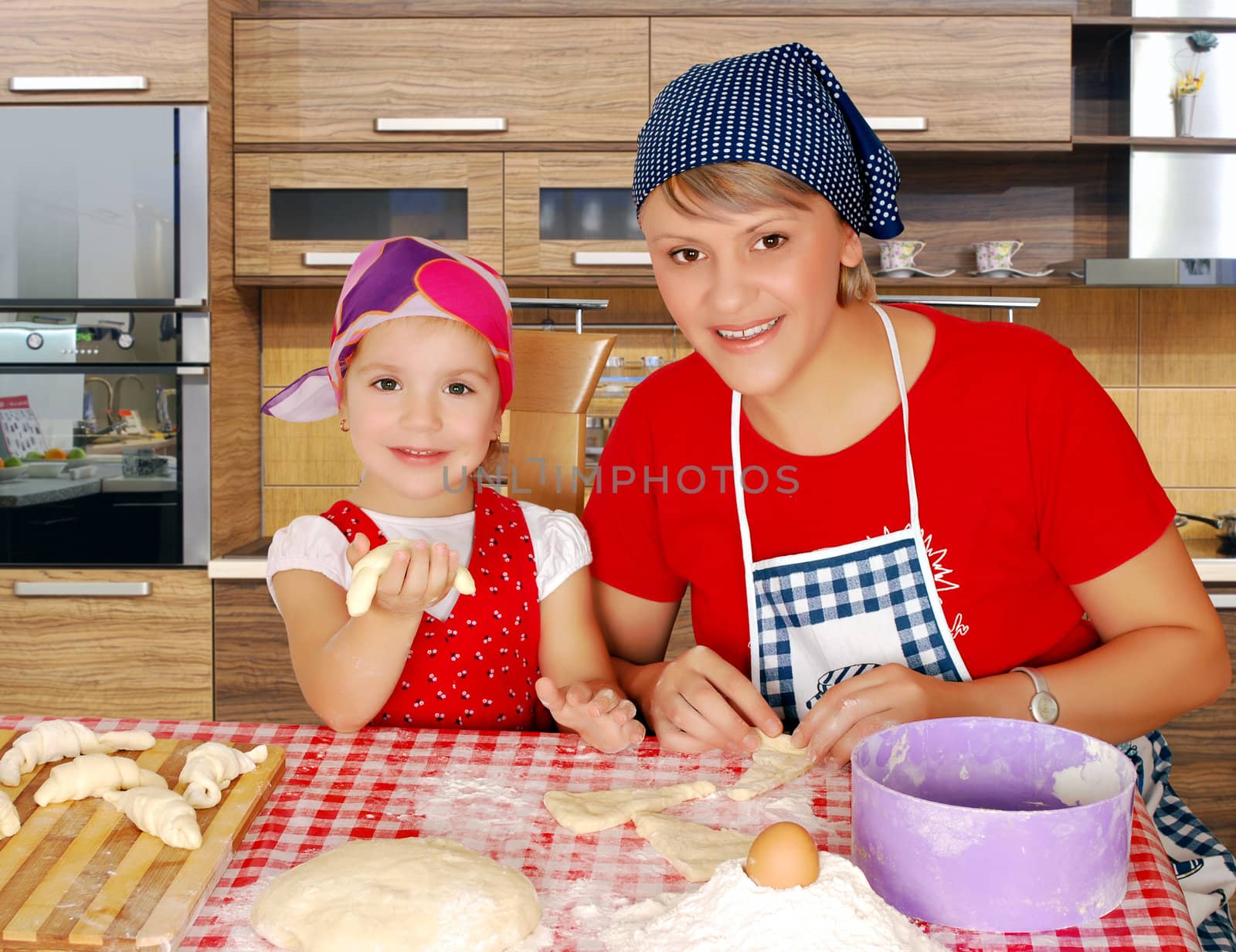 mother and daughter making rolls by goce