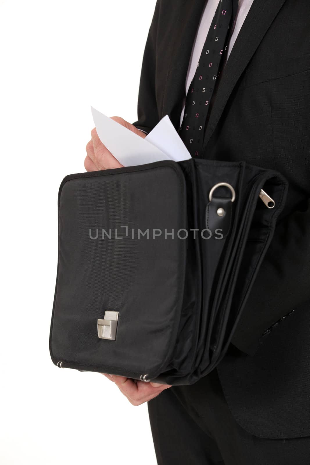 Man removing document from briefcase by phovoir