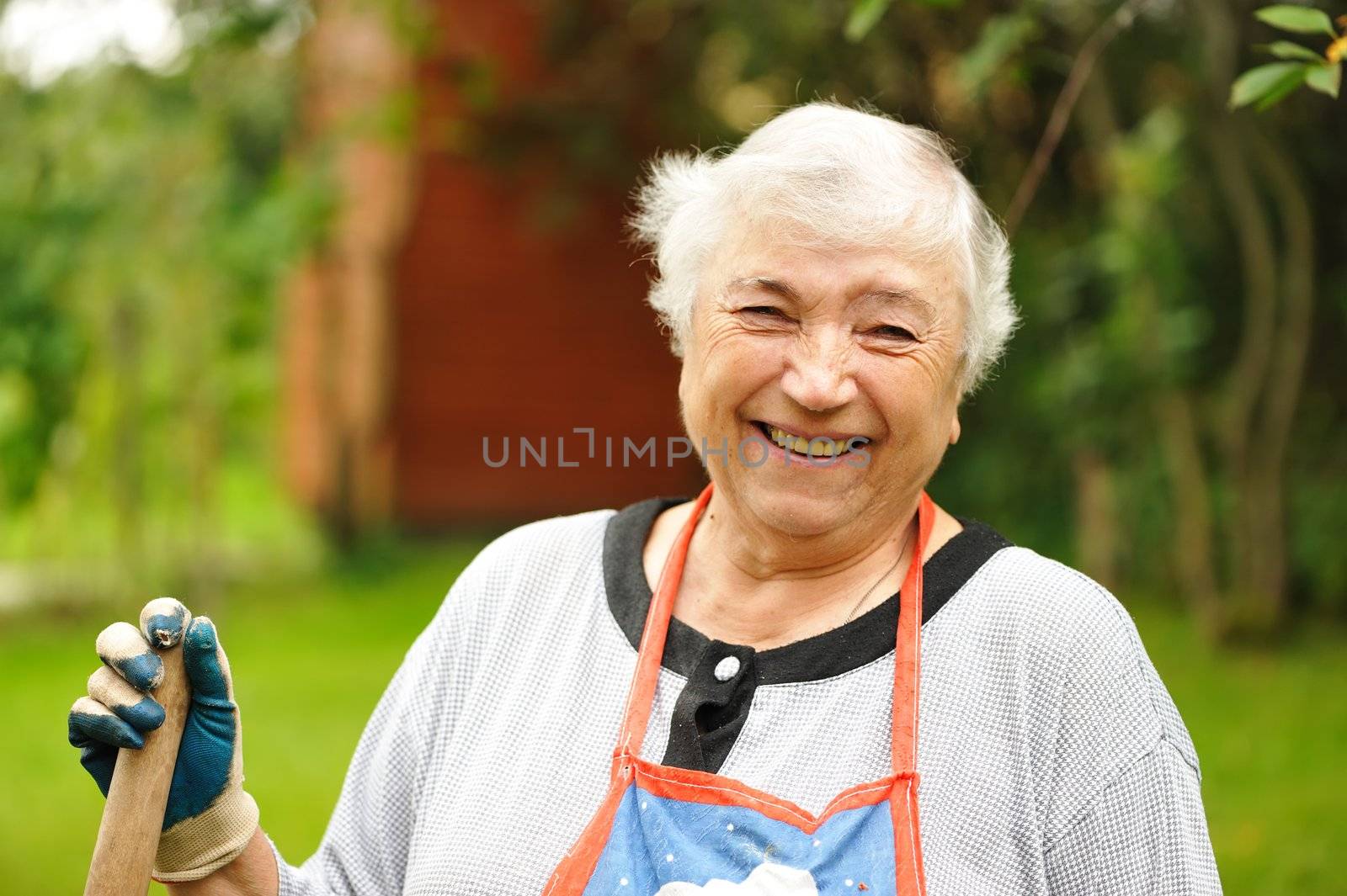 Senior woman in backyard smiling 