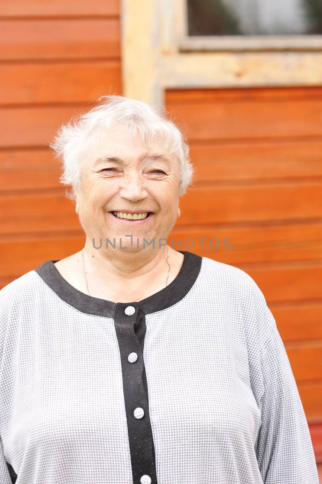 Senior woman in backyard smiling 
