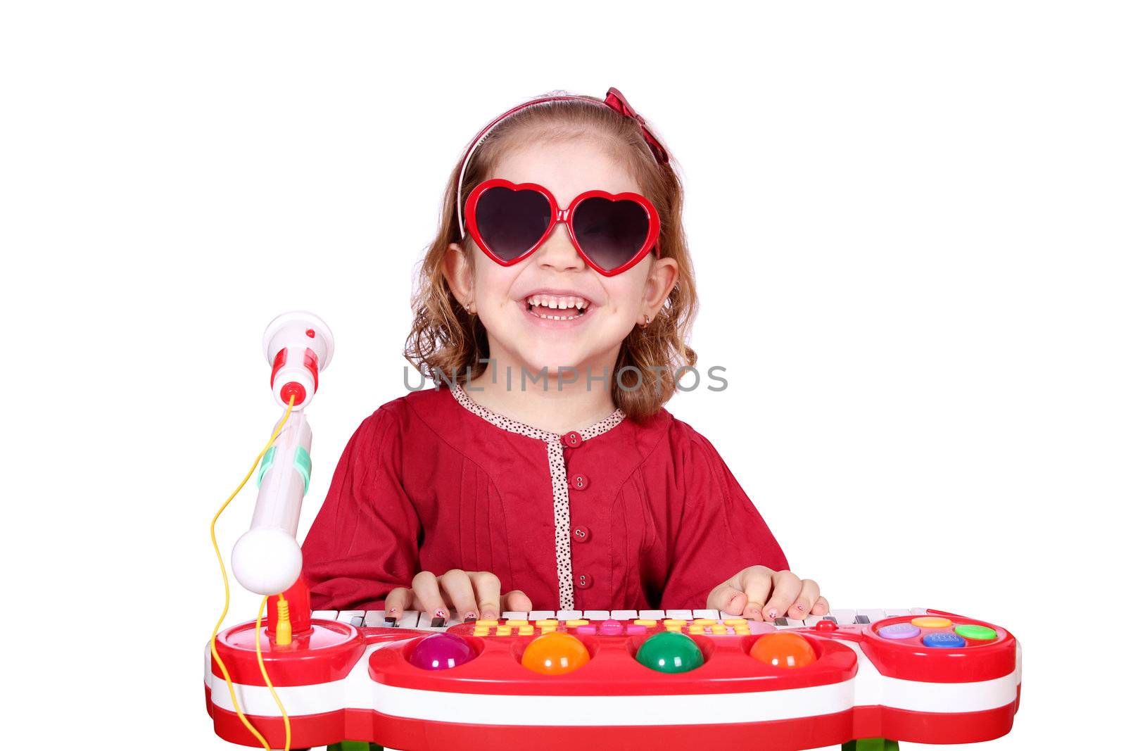 happy little girl with sunglasses play music