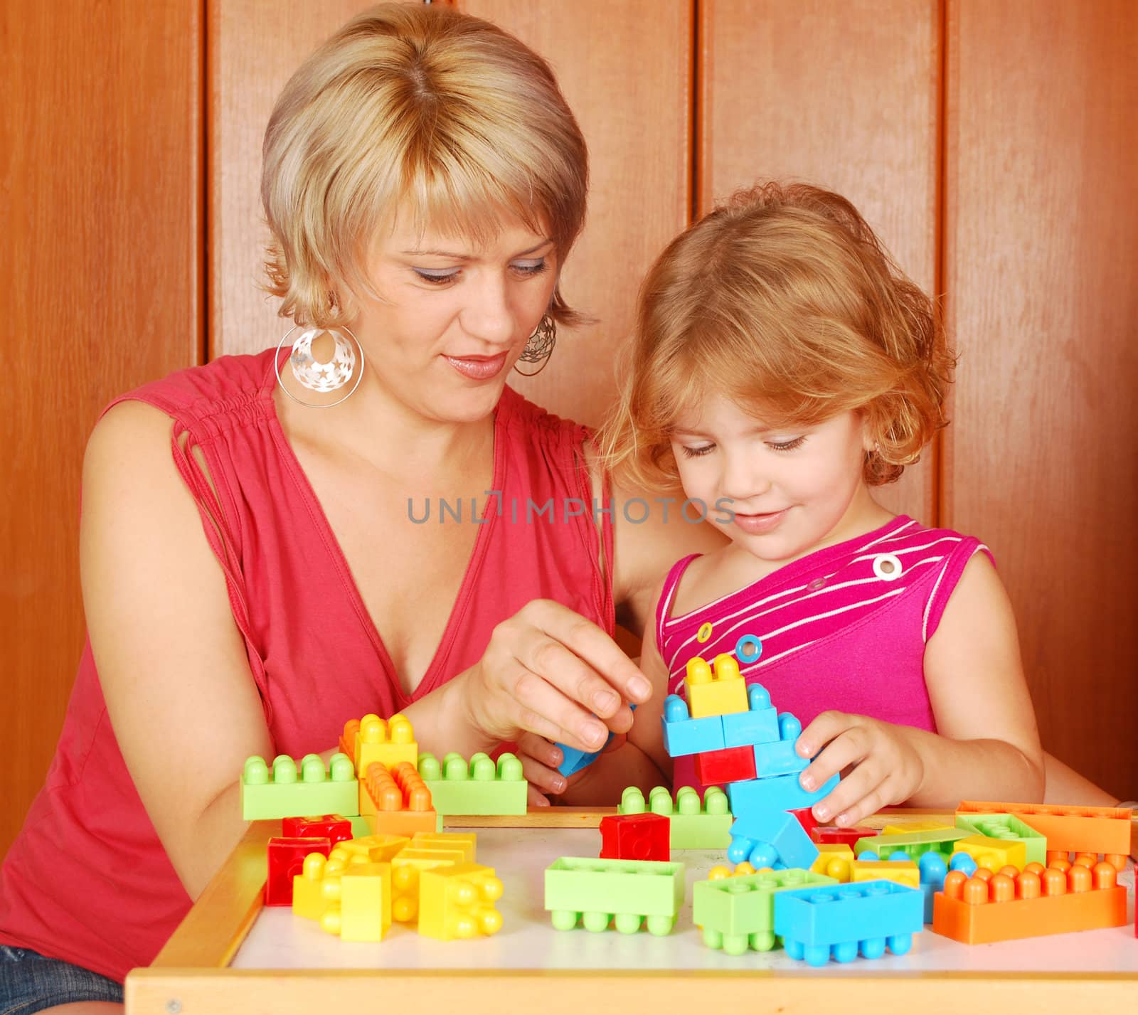 Mother and daughter playing with toy blocks