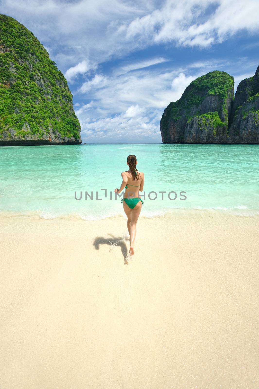 Woman running in water in beautiful lagoon at  Phi Phi Ley island, the exact place where "The Beach" movie was filmed