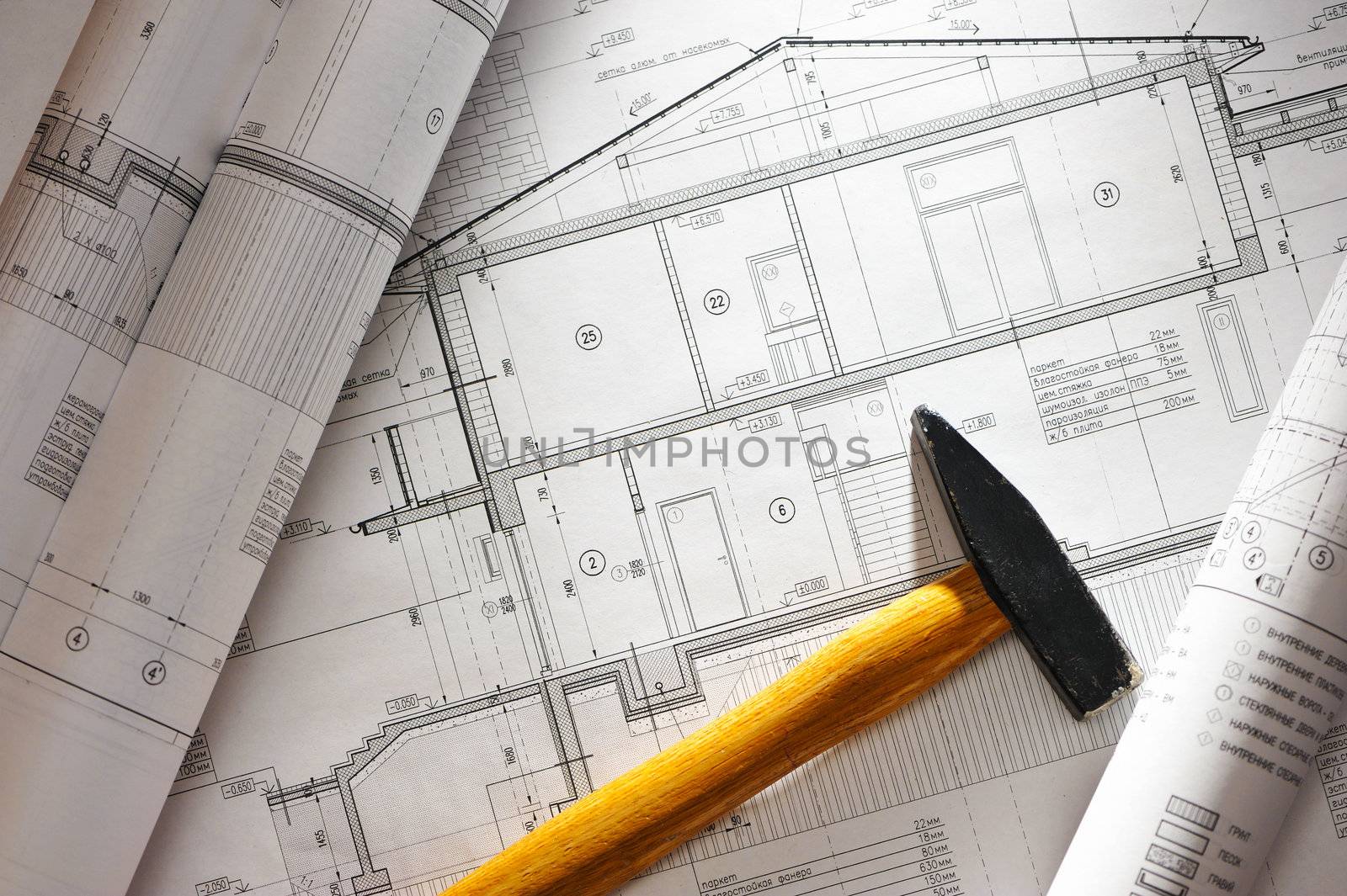 Hammer tool over house plan blue prints