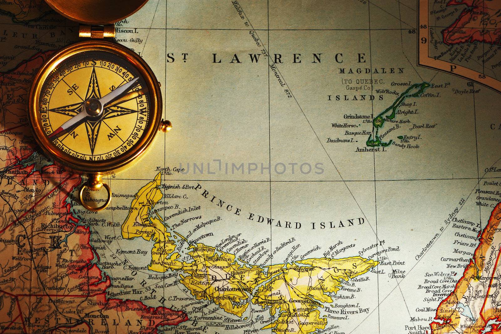 Antique brass compass over old Canadian map background