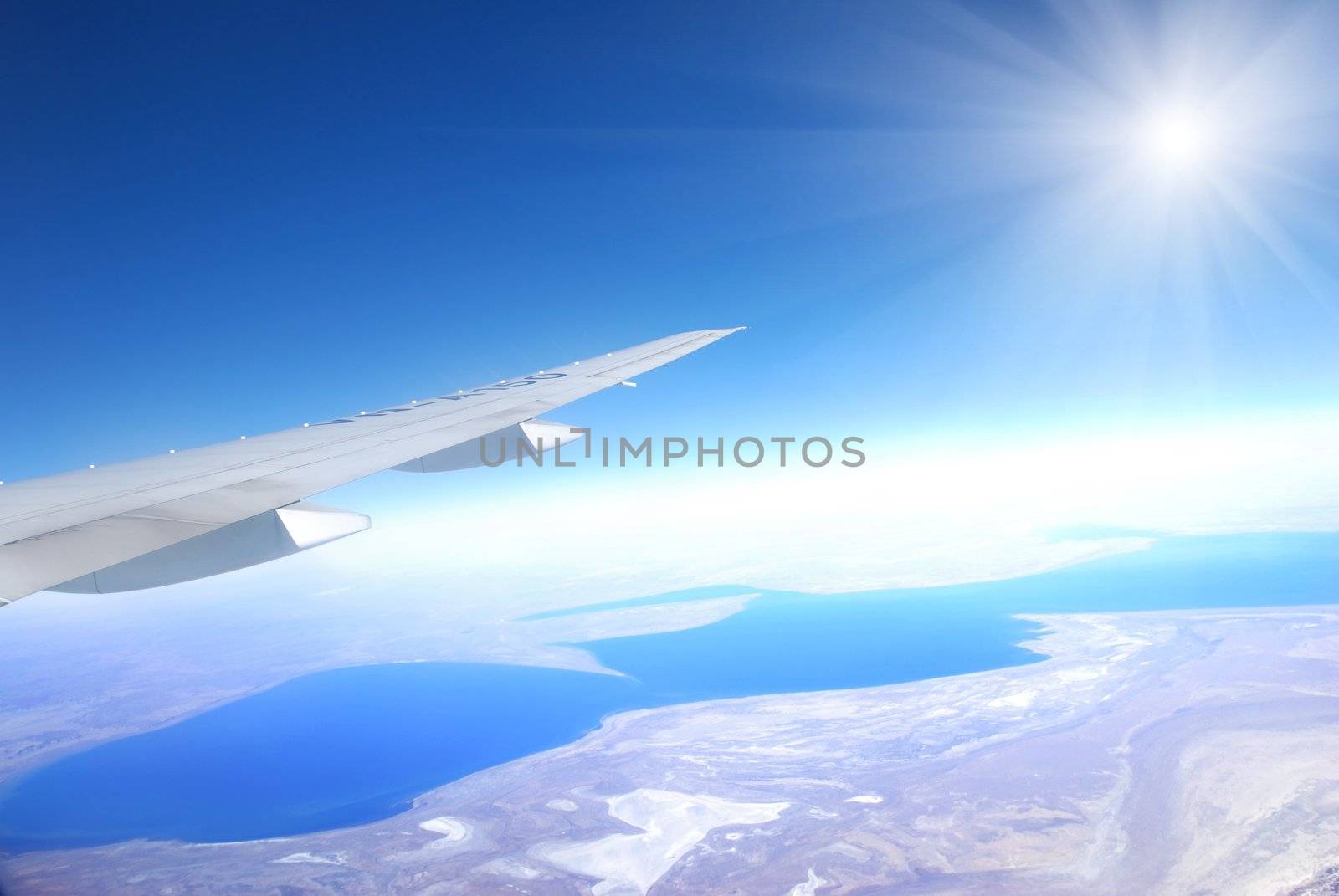 Plane wing against blue sky