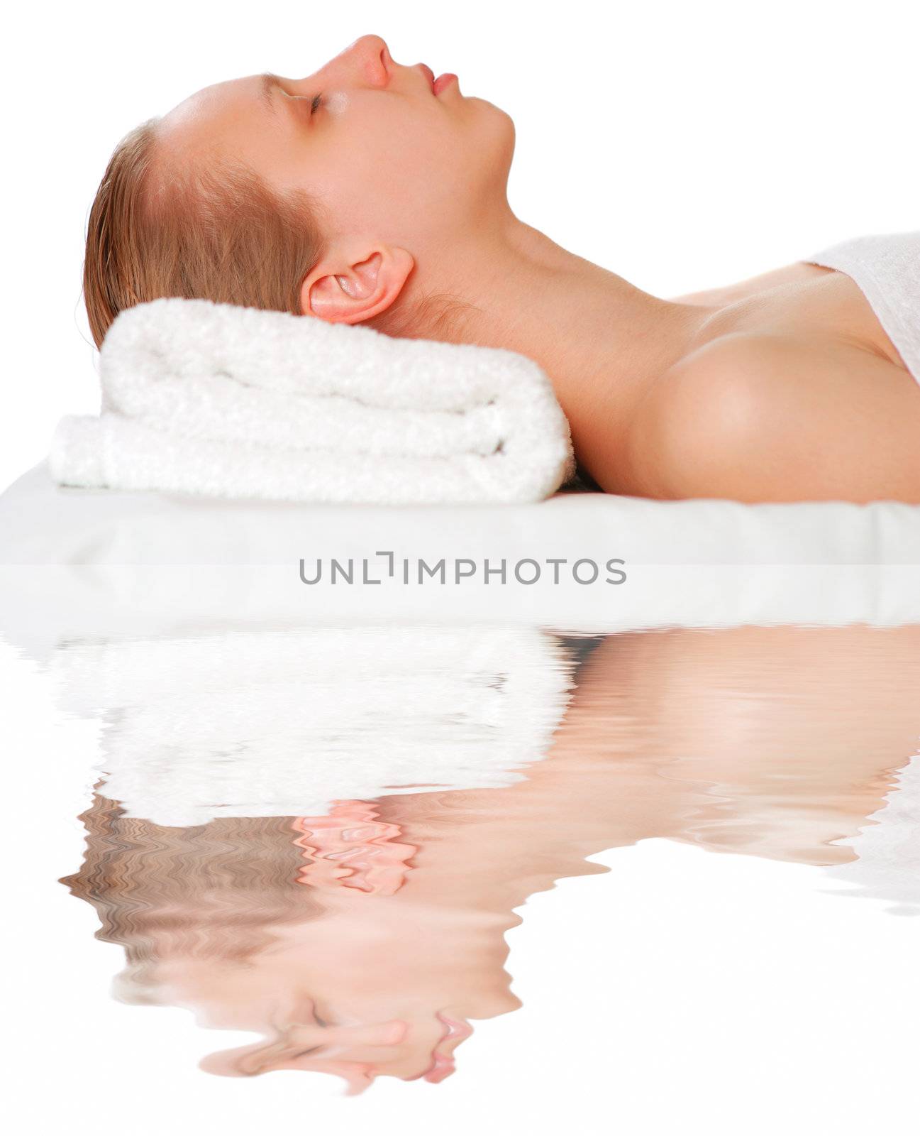 Woman laying on towel over white                                           