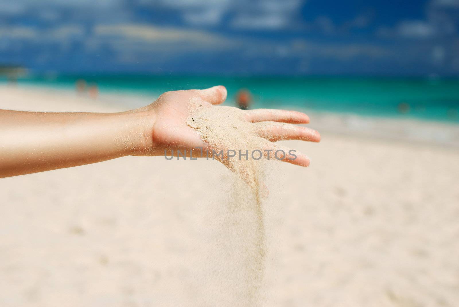 Coral white sand strewing from hand