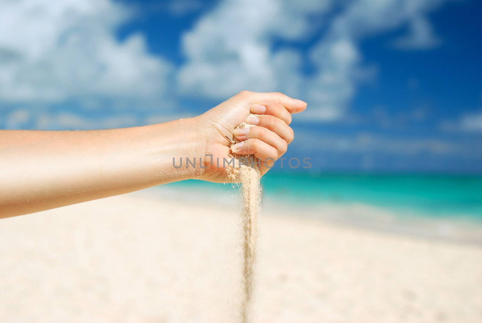 Coral white sand strewing from hand