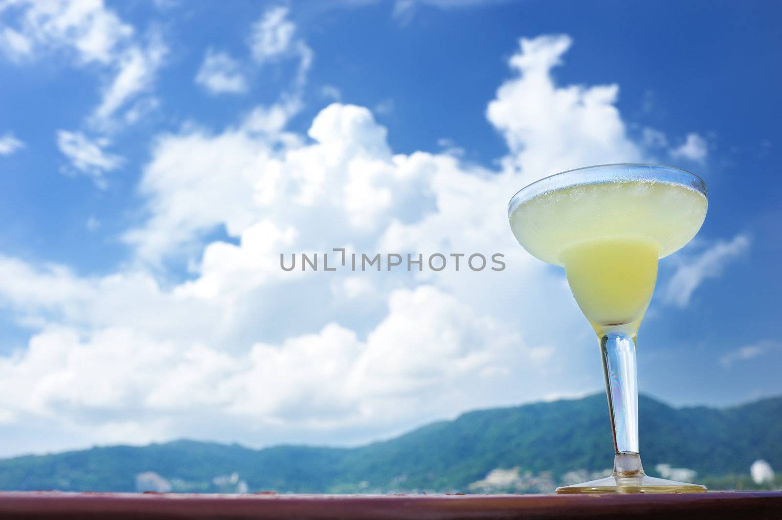 Margarita cocktail with sea and sky in background