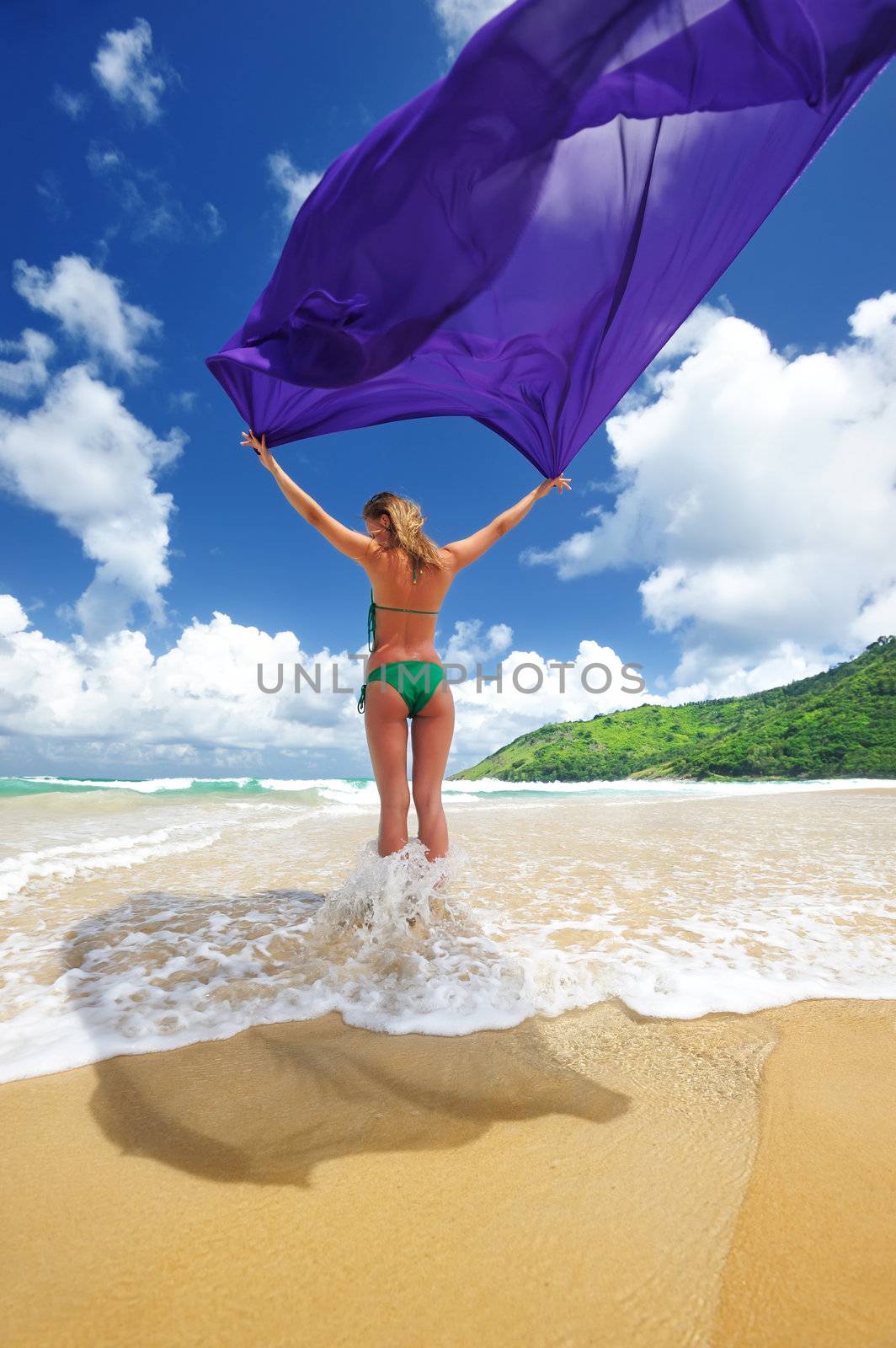 Woman with sarong on beautiful beach