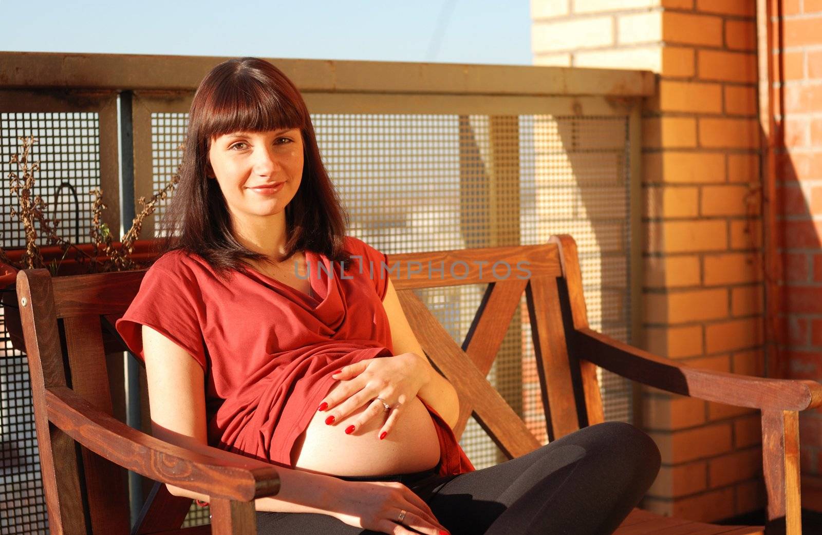 Pregnant woman waiting for a first child. Sunlight.