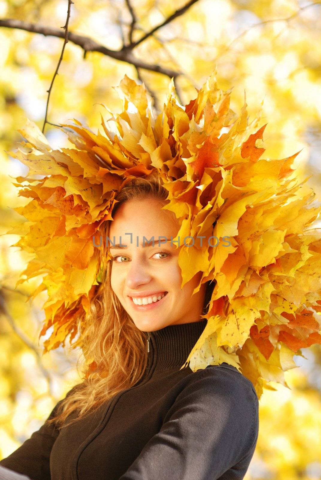 Girl with yellow autumn leaves