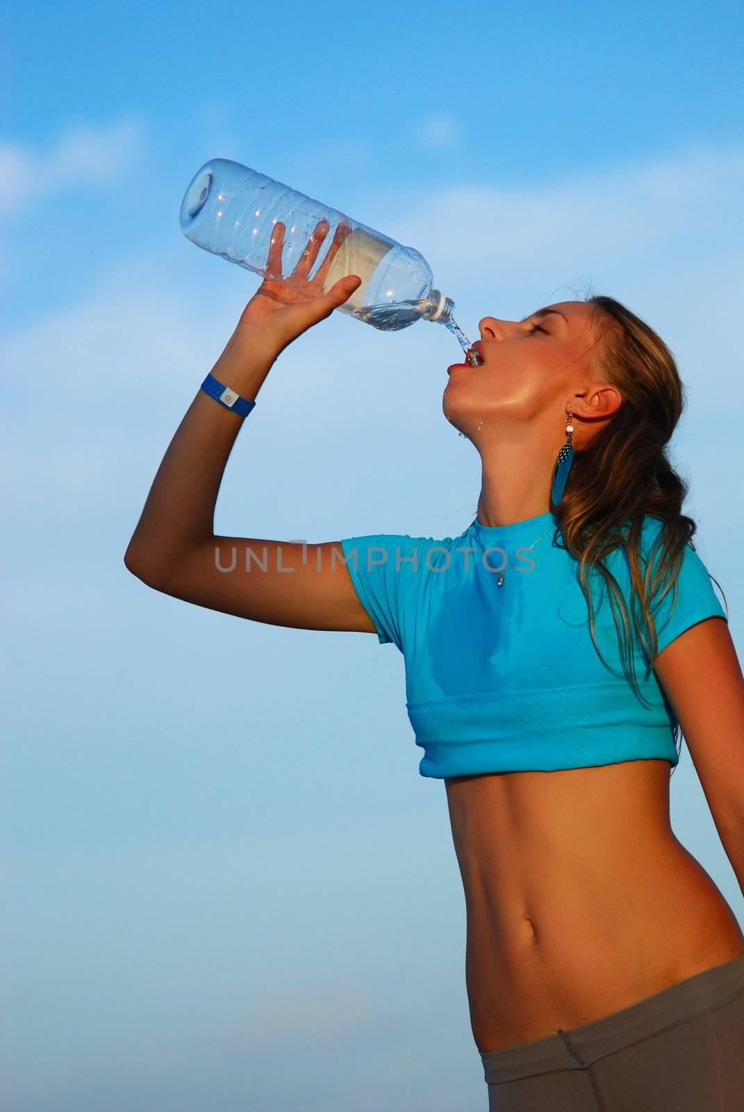 Woman drinking water after jogging