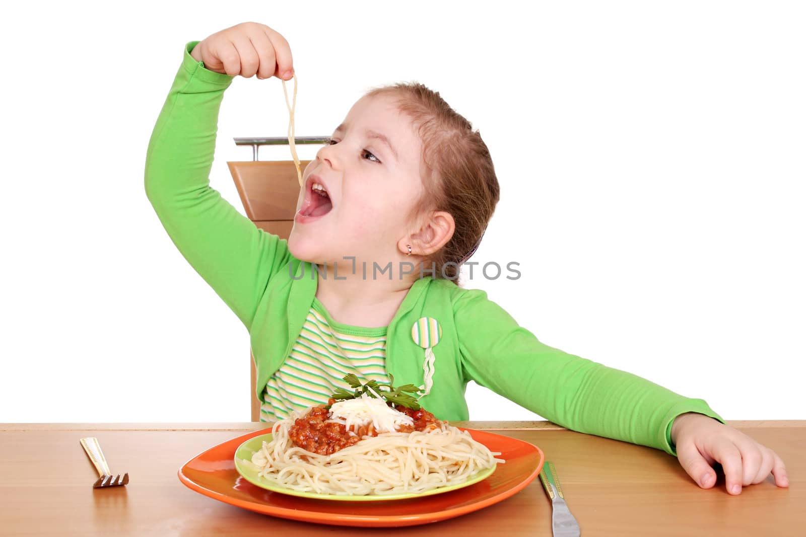four years hungry little girl eating spaghetti