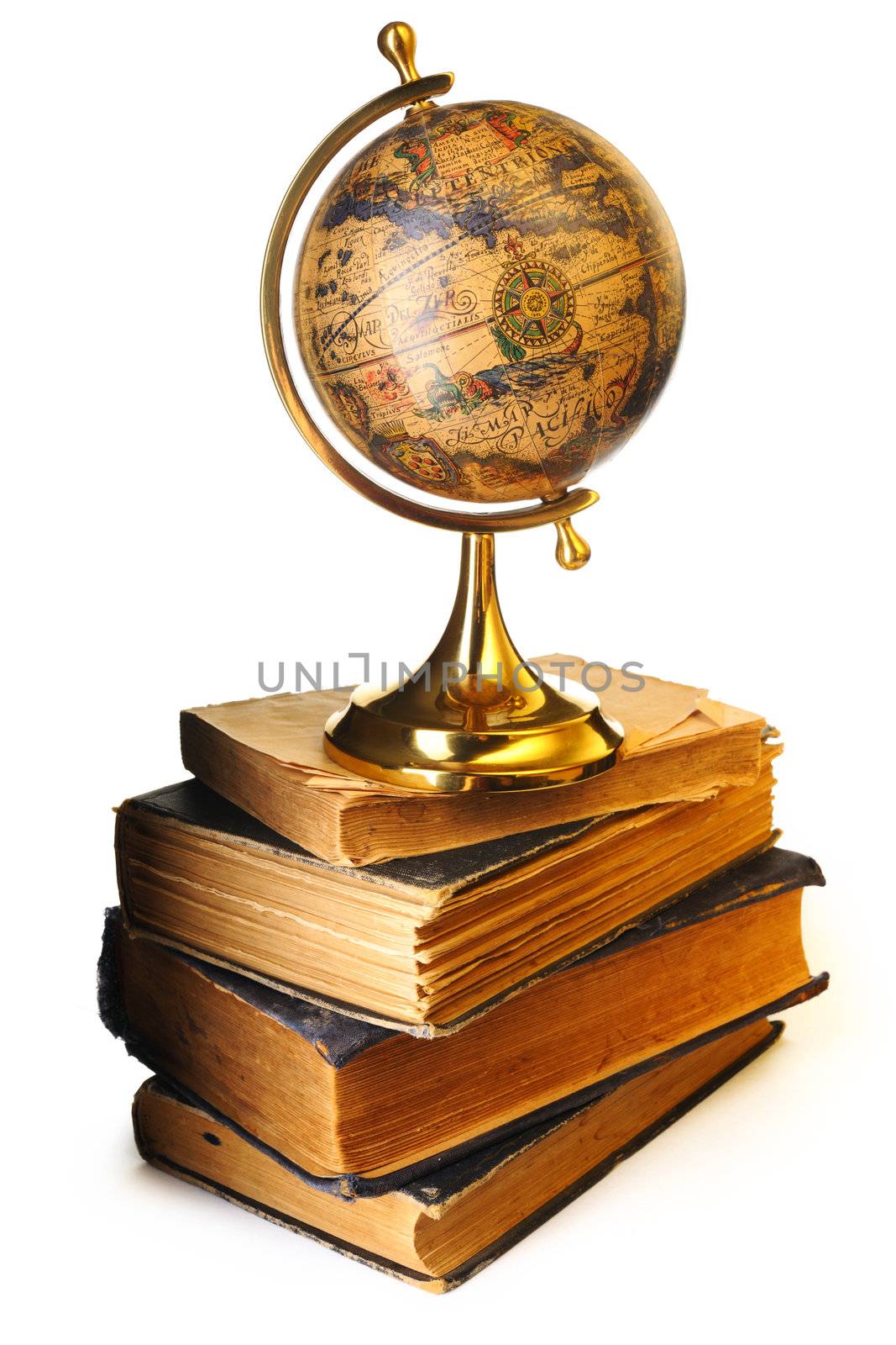 Antique globe on old books isolated over white