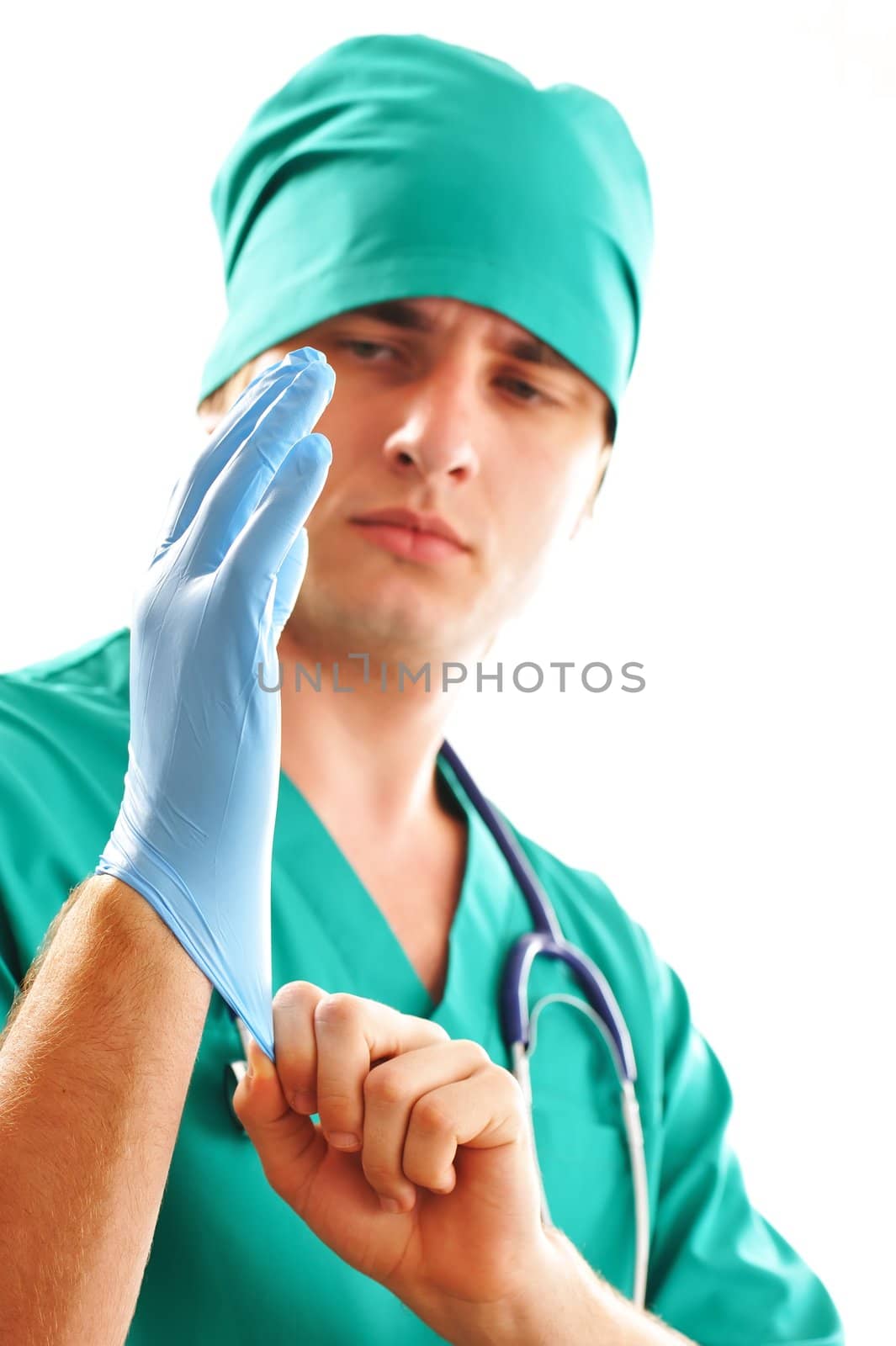Doctor pulling on surgical glove